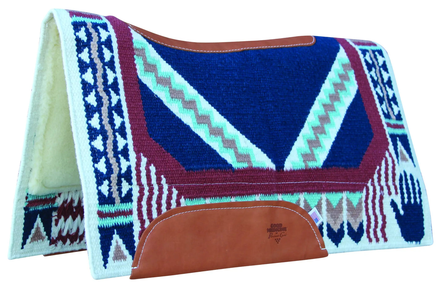 A contoured Western saddle pad featuring a navy blue, maroon, and teal Southwestern pattern on New Zealand wool. It includes a leather-reinforced spine and wear leathers embossed with the Good Medicine logo. The interior is lined with thick, plush cream fleece for comfort and impact protection.