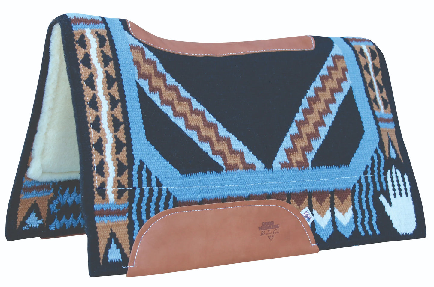Professional's Choice Good Medicine Western saddle pad features a black New Zealand wool base with intricate geometric designs in light blue, brown, and white, including a handprint motif. It has brown leather reinforcements along the spine and side wear leathers, with a thick cream fleece lining. The folded pad shows its contoured shape designed for a horse's back.