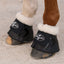 Professional's Choice Hard Shell Bell Boots in black with white fleece lining for superior comfort and overreach protection. These durable, shock-absorbing horse boots shield the coronary band and heels during training or turnout. Features a secure velcro closure with the brand logo. High-quality equestrian protective gear for horse hooves, ideal for jumping and performance horses.