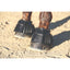 Professional’s Choice Bell Boot Rubber Open in black, shown on a horse's hooves. These durable ribbed rubber horse boots provide essential overreach protection for the heels. Featuring a secure hook and loop closure for an adjustable fit, they are perfect for daily training, jumping, or turnout to prevent injuries and lost shoes. High-quality equestrian gear for ultimate hoof protection and performance.