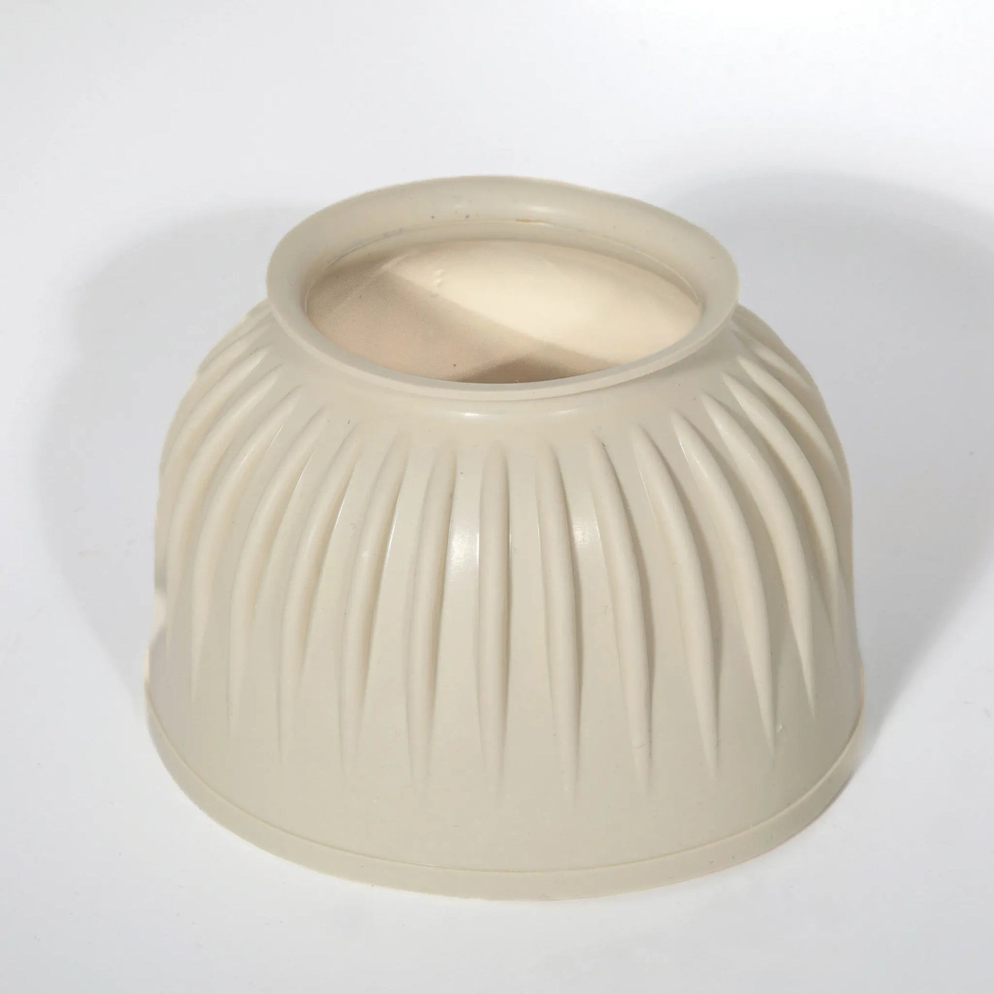 Professional's Choice Rubber Bell Boot in a neutral cream color, featuring a classic ribbed texture for impact resistance. Designed for overreach protection, this durable equestrian gear is ideal for turnout, training, or competition. High-quality, pull-on rubber horse boot providing a secure fit around the hoof and coronary band for ultimate equine safety and protection.