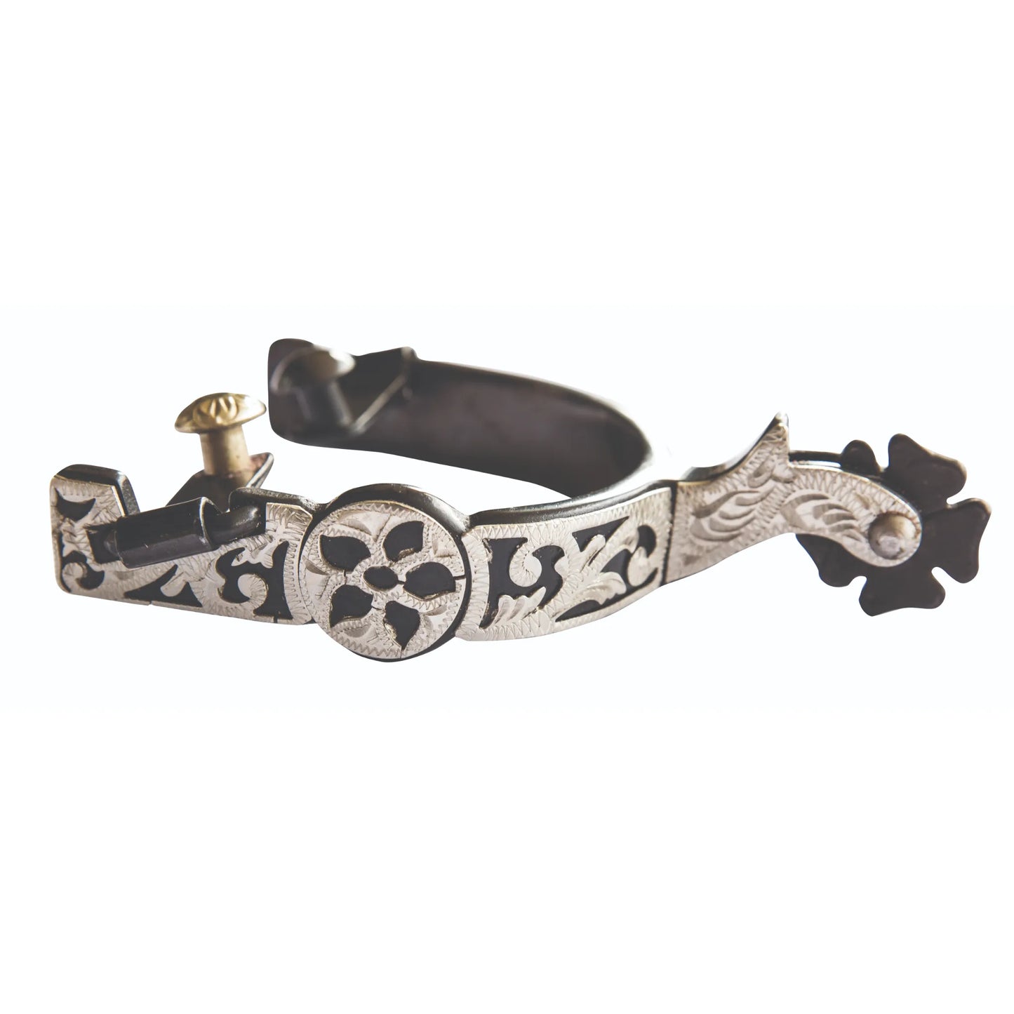 Professional’s Choice Brittany Silver Floral Spur for Western riding. This ornate equestrian accessory features intricate silver hand-engraved floral patterns on a blackened steel band and curved shank. Designed with a dark rowel and silver button, these high-quality spurs provide a stylish, professional look for horse showing or everyday trail riding. Elegant and durable silver floral Western spurs for riders.
