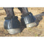 Black Professional’s Choice Fleece Open Bell Boots on a horse's hooves. Featuring a durable ribbed outer shell and plush black fleece trim to prevent chafing, these equestrian overreach boots offer superior hoof protection. The secure double-stitched hook-and-loop closure ensures a reliable fit during riding or turnout. High-quality horse gear designed for comfort and injury prevention in the arena or stable.