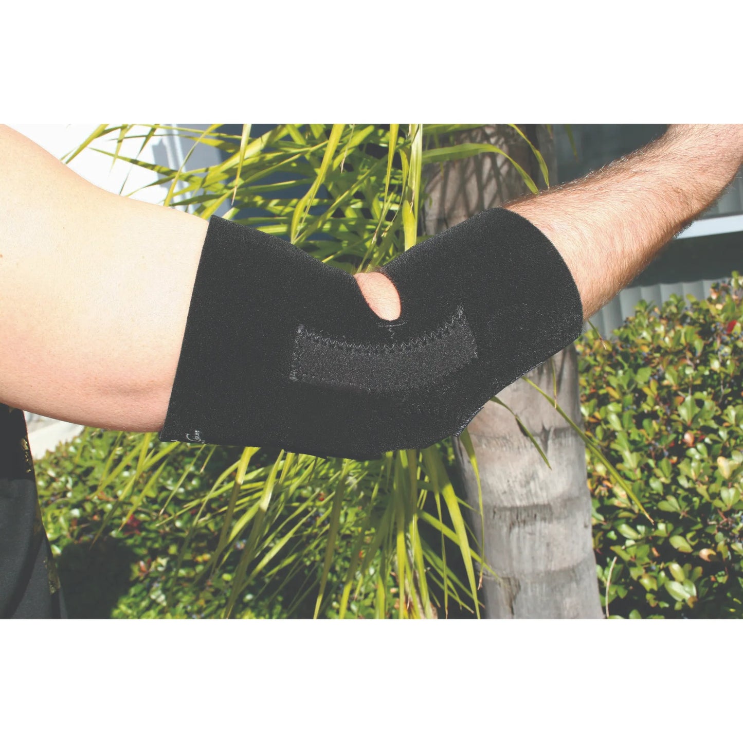 Professional's Choice Full Elbow Support in black, designed for superior joint stability and injury recovery. This neoprene elbow brace features a comfortable open-elbow design and adjustable hook-and-loop strap for a secure, custom fit. Ideal for athletes, tennis players, or everyday compression, it offers durable support against joint strain and tendonitis. Shown on a bent arm, highlighting its sleek, low-profile fit for active lifestyles and sports performance.