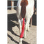 Bright red Professional's Choice Lycra Tail Bag tied securely to a pinto horse's tail to protect and preserve hair. This durable horse tail wrap prevents breakage and keeps tail hair clean from dirt and tangles in the pasture or stable. A must-have equestrian grooming accessory for maintaining a long, show-quality tail. Features stretchy, high-visibility lycra material designed for comfort and security.