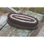 Professionals Choice Oval Wooden Horse Hair Brush for gentle equestrian grooming. Features a dark wood base with soft, dense bristles arranged in a stylish concentric pattern of black, brown, and white. This premium horse brush is ideal for finishing coats and daily care. Shown in a rustic outdoor setting, perfect for horse owners seeking high-quality, professional-grade grooming supplies.