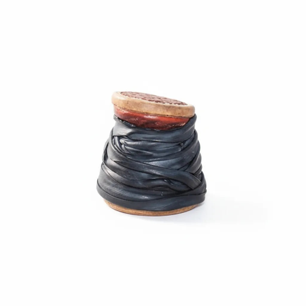 Classic Equine Dally Wrap featuring 1" wide black inner tube rubber coiled for saddle horn protection. This durable roping accessory is designed for team roping and ranch work, providing a secure grip and preventing wear on the horn. Shown as a compact roll with a textured black finish and a tan core, these essential rubber wraps are a must-have for any western roper's gear bag.