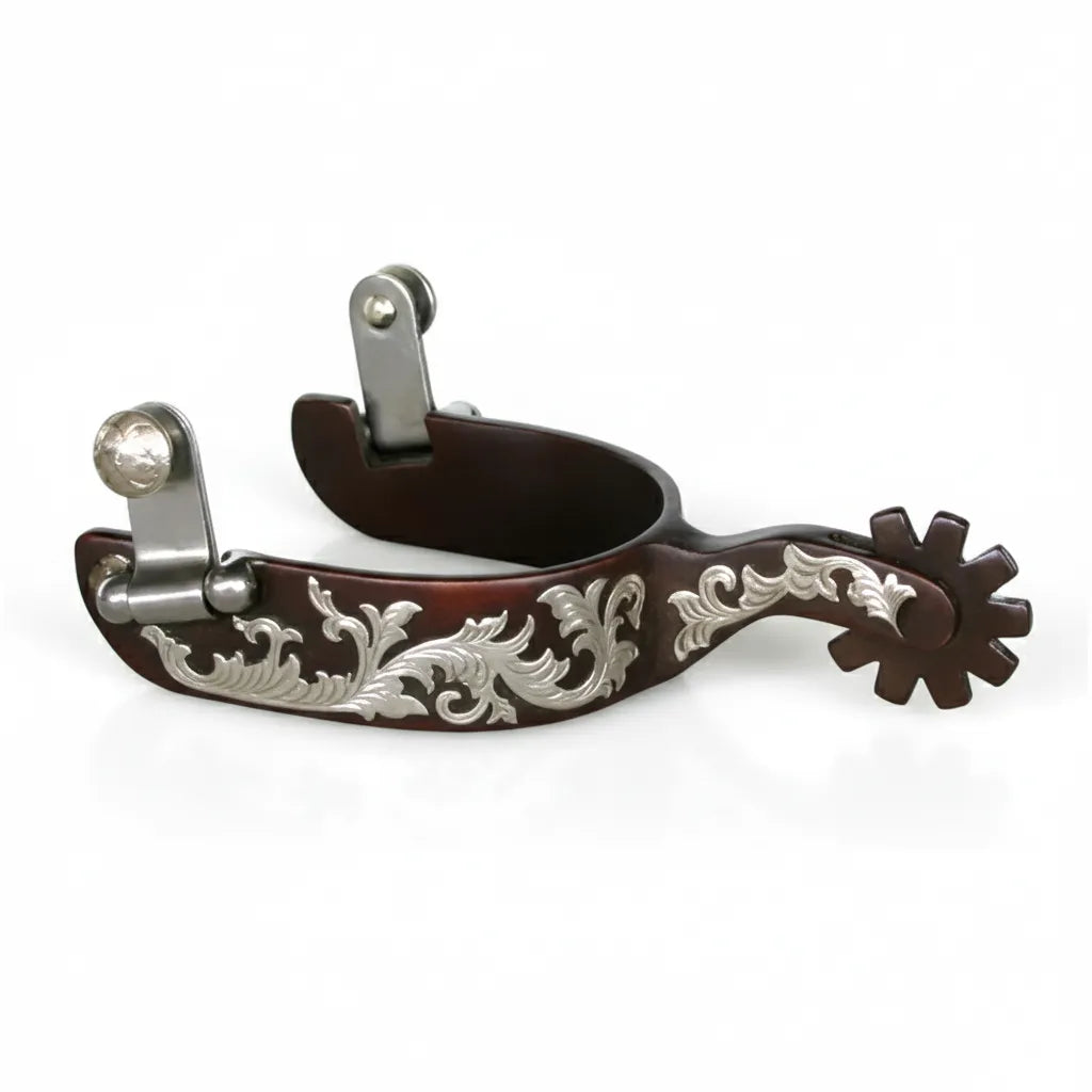 Professional's Choice Bob Avila Lady Floral Spur featuring a rich browned steel 1" band decorated with intricate silver floral engraving. This stylish western riding gear includes a 2 1/4" shank and a 10-point blunt rowel, perfect for refined communication. These elegant cowgirl spurs combine vintage western aesthetics with professional performance, making them a must-have for show or daily equestrian use.