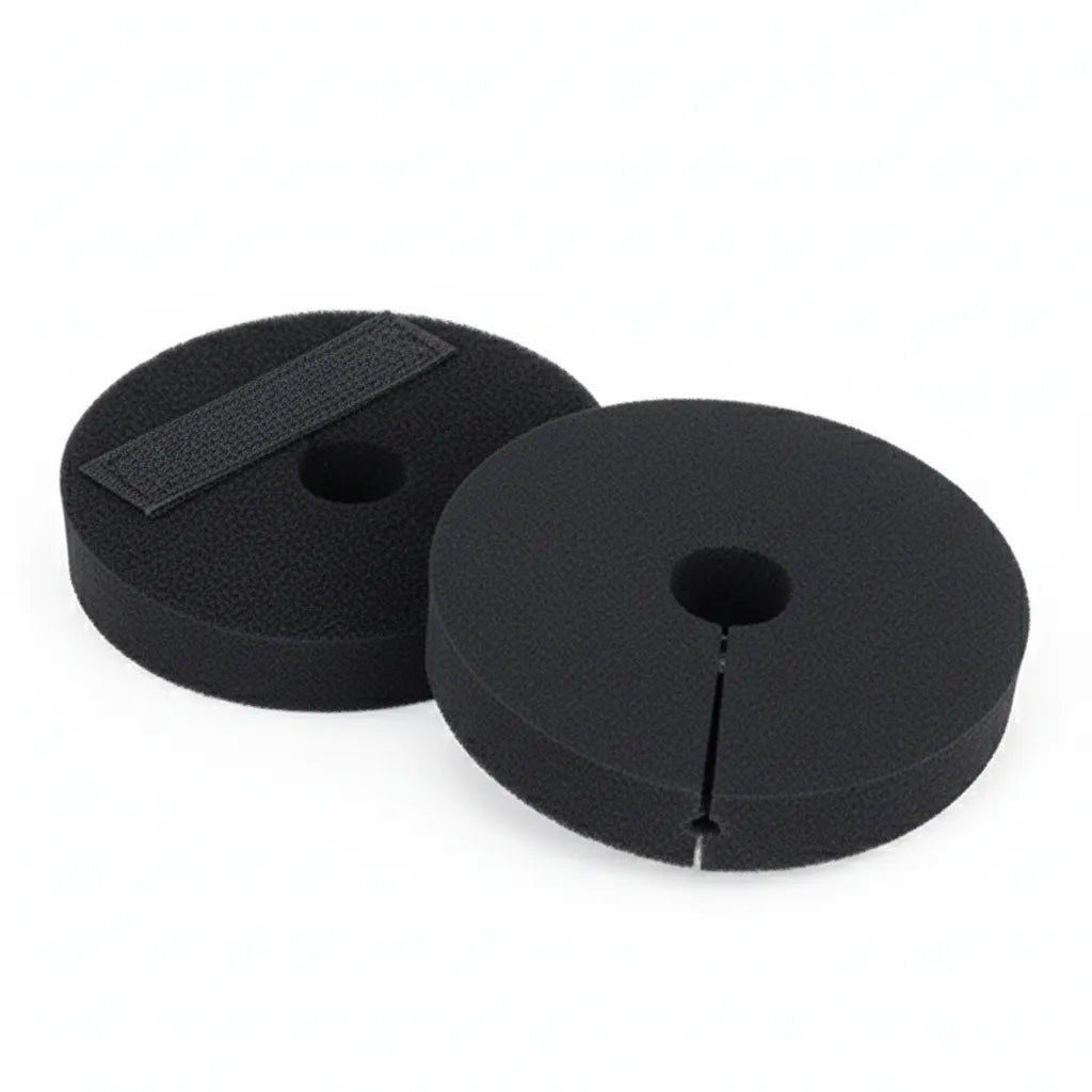 Pair of black Weaver Leather Neoprene Bit Guards with a universal fit and hook and loop closures. These circular horse bit accessories feature a slit and center hole for easy attachment, preventing bit pinching and improving equine comfort. Durable, professional-grade equestrian tack perfect for training and daily riding.