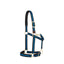 Weaver Equine Breakaway Horse Halter featuring stylish black and electric blue striped nylon webbing. Designed for safety and comfort, it includes a leather breakaway fuse, padded nose and crown, and premium brass hardware. This durable halter offers a custom fit with an adjustable chin strap and crown, plus a convenient throatlatch snap, making it a reliable and attractive choice for everyday use and pasture safety.