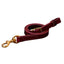 Premium Weaver Equine Latigo Leather Tie Down Strap in a rich burgundy finish. This durable horse tack features a sturdy solid brass snap and adjustable buckle for maximum reliability. Designed with elegant white contrast stitching, this high-quality western riding equipment is built to last. A professional-grade equestrian essential perfect for training and performance.
