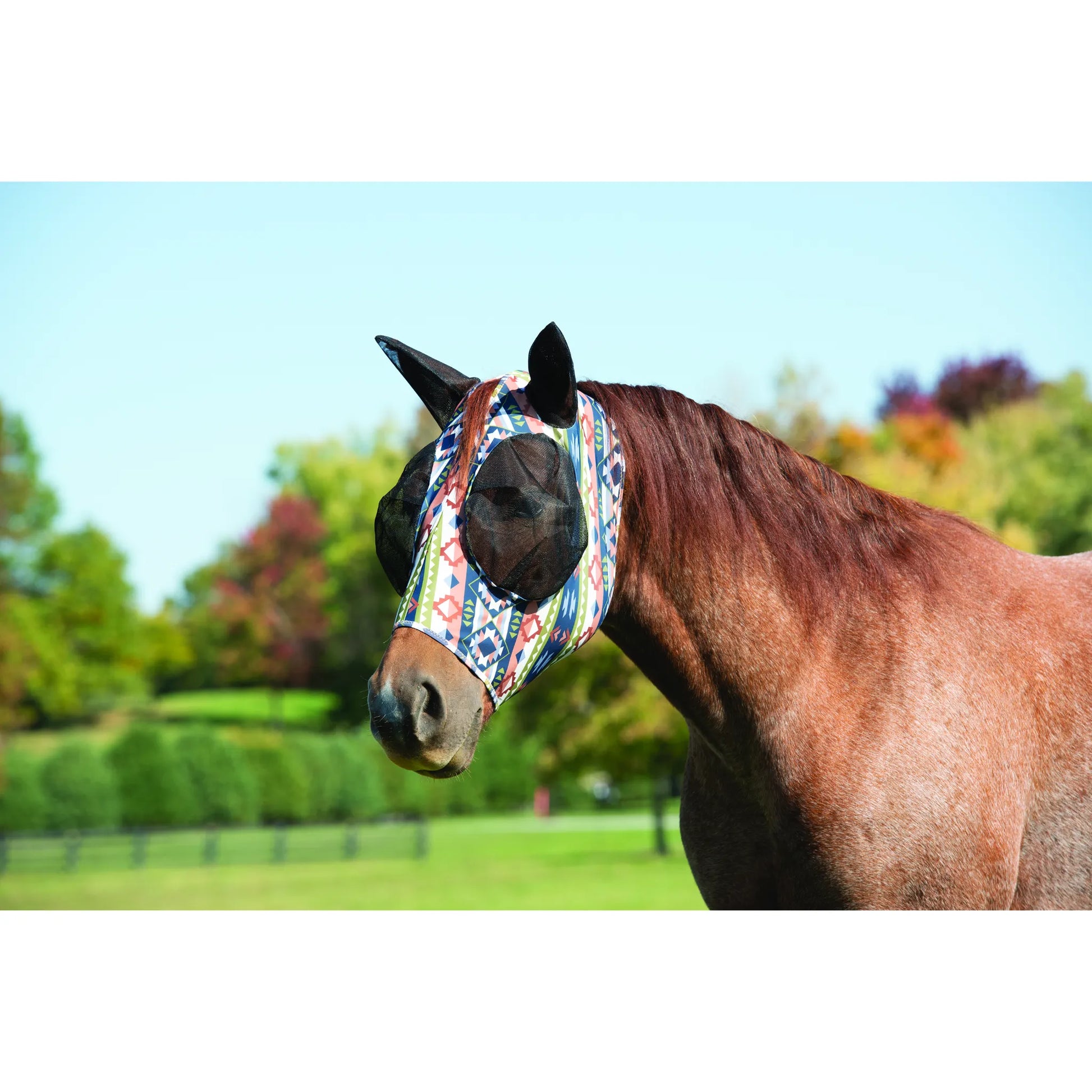 Weaver Leather Lycra® Fly Mask in a vibrant Southwest geometric pattern, providing ultimate protection for horses. This stretchy, breathable fly mask features black mesh eye covers and ear holes to keep insects away while ensuring visibility and comfort. Shown on a chestnut horse in a sunny pasture, this stylish equine accessory is a must-have for summer horse care and pest control.