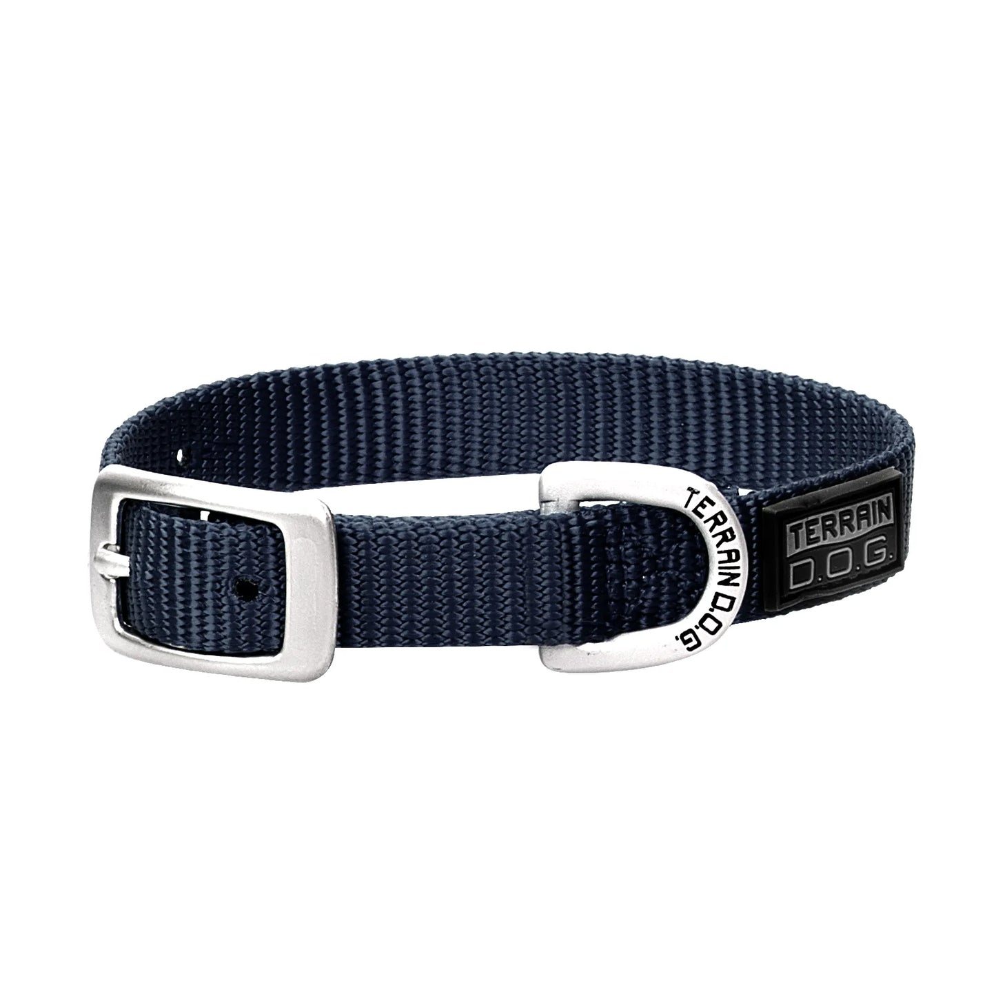 Navy blue Weaver Leather Terrain D.O.G. nylon dog collar featuring heavy-duty, double-ply webbing. This durable pet accessory includes a classic silver-tone buckle and a sturdy silver D-ring etched with the Terrain D.O.G. name for easy leash attachment. A stylish black rubber brand patch highlights its rugged quality, making it an ideal choice for active dogs on every outdoor adventure.