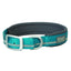 Reflective teal Terrain D.O.G. padded dog collar by Weaver Leather featuring a vibrant teal nylon strap with a gray reflective strip for nighttime safety. This high-visibility collar includes a soft, dark gray padded lining for maximum comfort and a durable silver-finish metal buckle and D-ring. Perfect for active dogs, this stylish and functional pet accessory ensures visibility and durability for all your outdoor adventures.