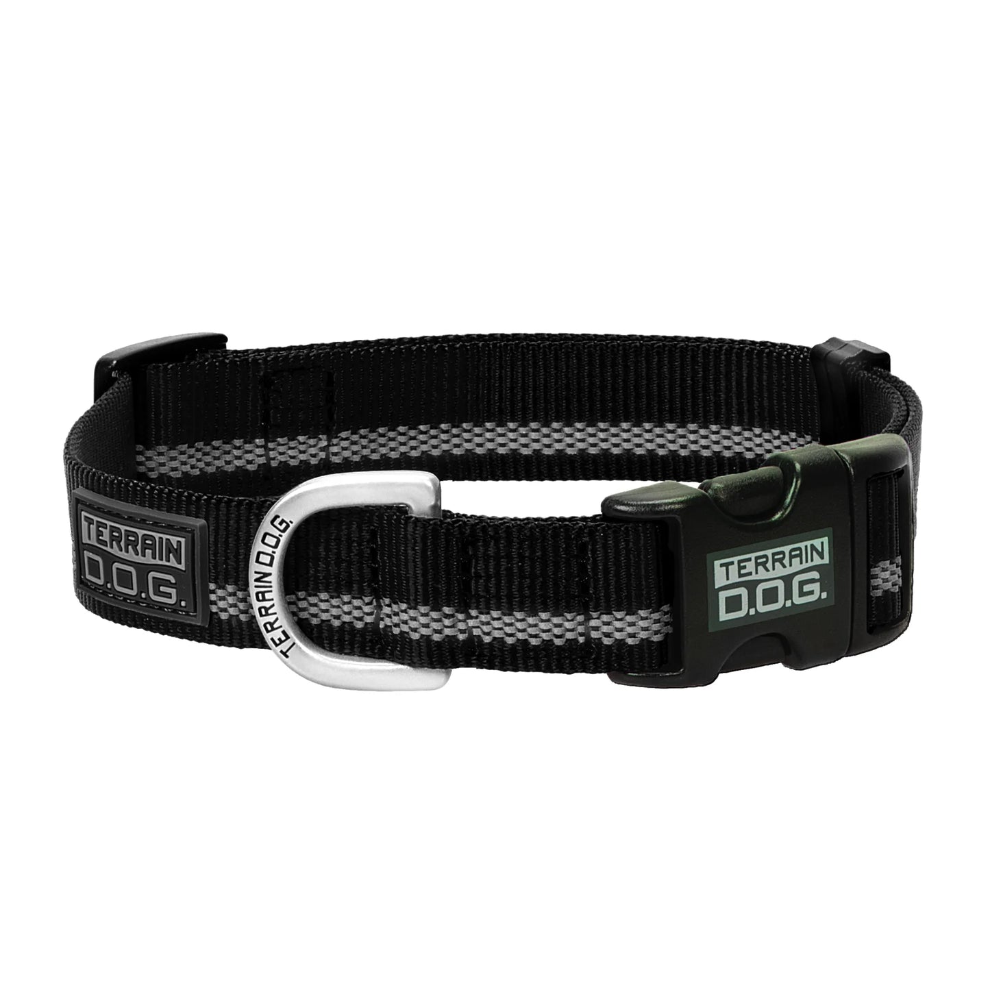Black and grey Weaver Leather Terrain D.O.G. Reflective Snap-n-Go dog collar features a durable black nylon webbing with a high-visibility silver reflective stripe. This stylish safety collar includes a sturdy black plastic side-release buckle and a heavy-duty metal D-ring for leash attachment. Perfect for nighttime walks, it's branded with the Terrain D.O.G. logo on the buckle, D-ring, and a sleek rubber patch for an adventure-ready look.